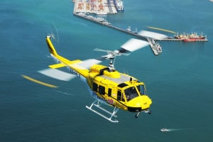 Working on Fire Huey Helicopter over Table Bay harbour in Cape Town South Africa